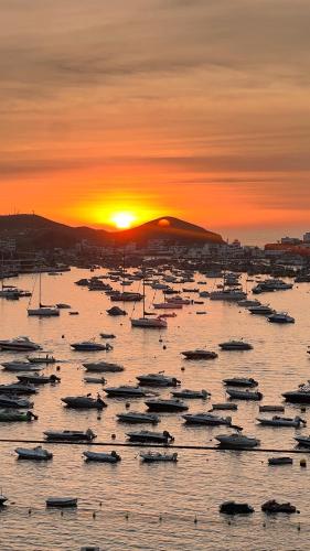 a group of boats in the water at sunset at Ocean View Premiere Depa Naplo in Naplo