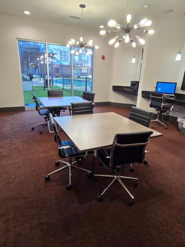 a conference room with tables and chairs and pianos at Cozy 1bedrm/1bed/air mattress in Dallas