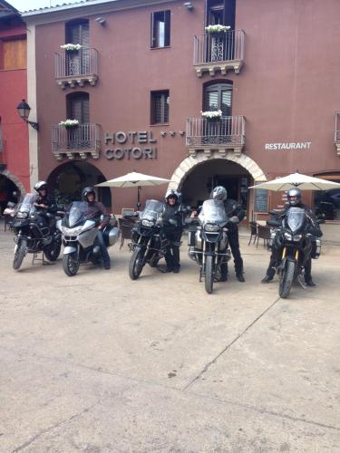 a group of people riding motorcycles in front of a hotel at Hotel Cotori in El Pont de Suert