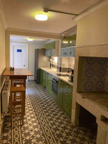 a kitchen with a fireplace and a table in it at Maris Alsancak City Center in Konak