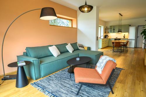 a living room with a blue couch and a chair at Pausenhof Spreewald in Unterspreewald