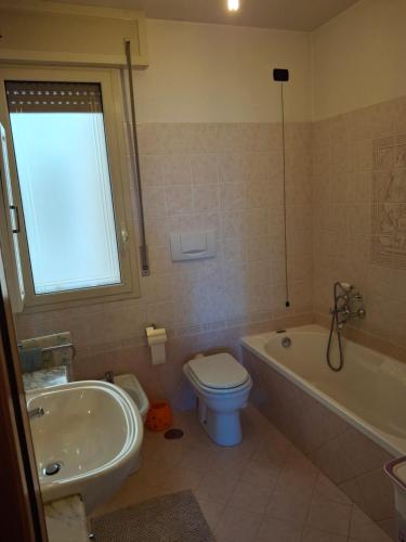 a bathroom with a tub and a toilet and a sink at Al Civico Centocinquantasei in Latiano