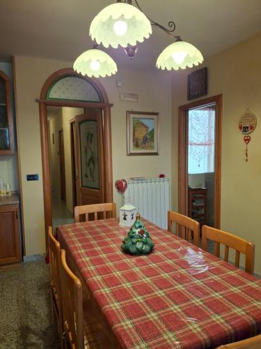 a dining room with a table with a red plaid table cloth at Al Civico Centocinquantasei in Latiano