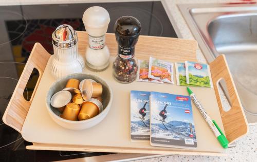 a tray with a bowl of food and a book at Apartmenthaus Pernull in Tröpolach