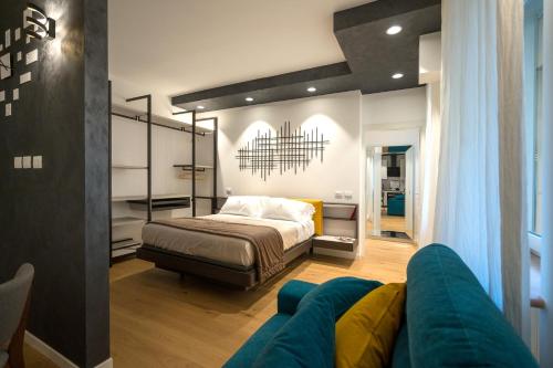 a bedroom with a bed and a couch at Callas Luxury Suite Verona in Verona