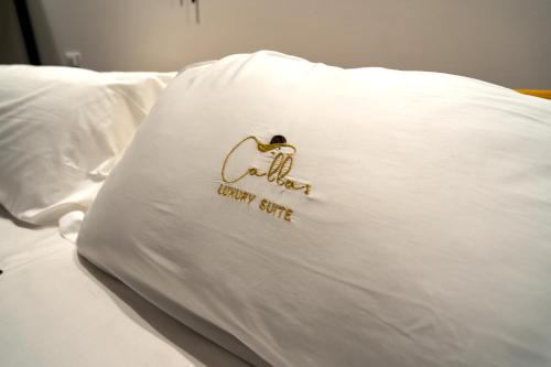a pillow on a bed with a sign on it at Callas Luxury Suite Verona in Verona