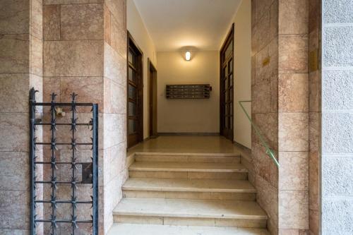 a hallway of a building with stairs and a gate at Callas Luxury Suite Verona in Verona