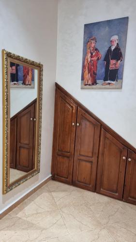 a room with wooden cabinets and a mirror on the wall at Maison Taha in Azrou