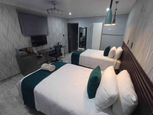 Ένα ή περισσότερα κρεβάτια σε δωμάτιο στο Delux Guesthouse