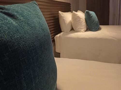 Ένα ή περισσότερα κρεβάτια σε δωμάτιο στο Delux Guesthouse