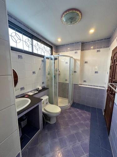 a bathroom with a toilet and a shower and a sink at Honey Moon view in Bophut 