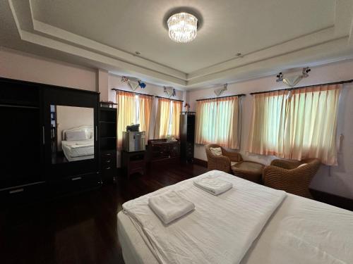 a bedroom with a white bed and a couch at Honey Moon view in Bophut 