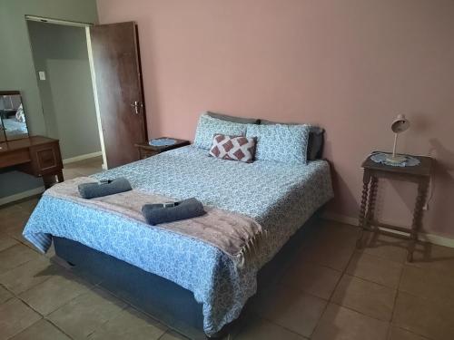a bedroom with a bed with two pillows on it at The View Holiday Home in Graskop