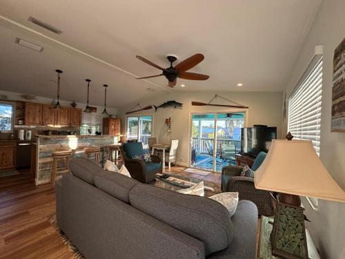 a living room with a couch and a ceiling fan at Cedar Cottage in Big Pine Key