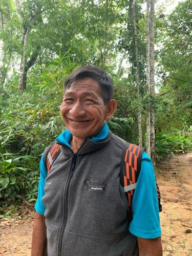 a man with a backpack standing in a forest at Casa Amazonas in Puerto Maldonado