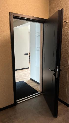 an open door in a room with an open door at New and modern Scandinavian style apartment in Sigulda