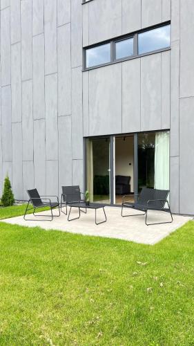 a group of benches in front of a building at New and modern Scandinavian style apartment in Sigulda