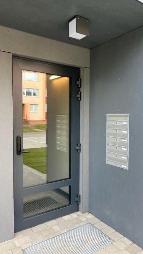 a glass door with a window on a building at New and modern Scandinavian style apartment in Sigulda