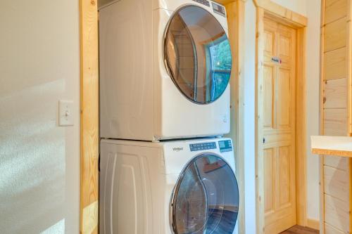 two washing machines in a kitchen next to a refrigerator at 15 Mi to Lake Superior Renovated Church with Grill in Toivola