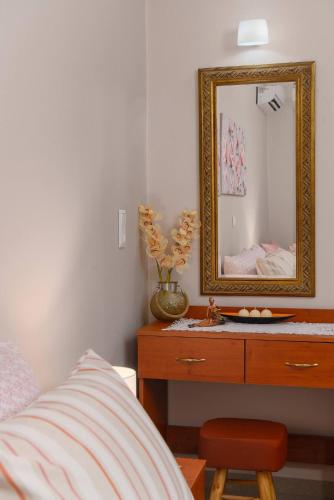 a bedroom with a dresser with a mirror and a bed at Anastasia's House in Plátanos