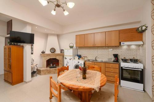 a kitchen with a wooden table and a kitchen with a stove at Anastasia's House in Plátanos