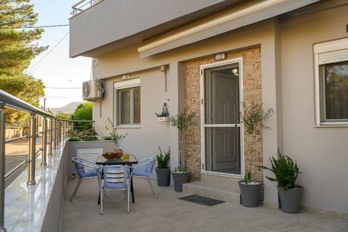 a patio with a table and chairs on a balcony at Anastasia's House in Plátanos