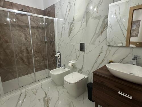 a bathroom with a shower and a toilet and a sink at Royal Residence in Santa Maria Capua Vetere