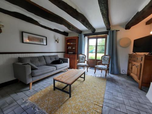 a living room with a couch and a table at Châteauneuf-du-Faou, Finistre, Brittany in Châteauneuf-du-Faou