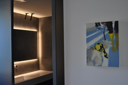 a bathroom with a mirror next to a sink at Bfour in Pergine Valsugana