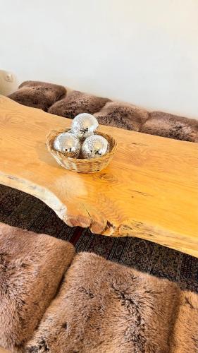 a bowl of silver balls on a wooden table at Arrayanes Royal in Sierra Nevada