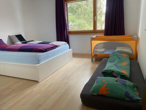 a bedroom with two beds and a bunk bed at Rietidylle mit atemberaubendem Blick auf die Churfirsten in Wildhaus