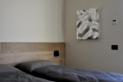 a bedroom with two beds and a painting on the wall at Bfour in Pergine Valsugana