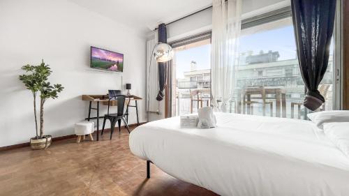 a bedroom with a white bed and a large window at Coloc Dormant - Hyper-centre, proche transports pour Genève. in Annemasse
