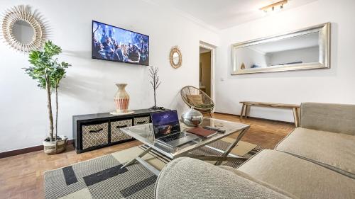 a living room with a couch and a glass table at Coloc Dormant - Hyper-centre, proche transports pour Genève. in Annemasse