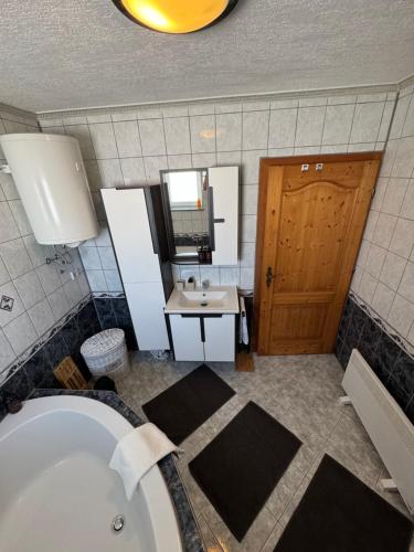 a bathroom with a bath tub and a sink at Apartman Latice in Tomislavgrad