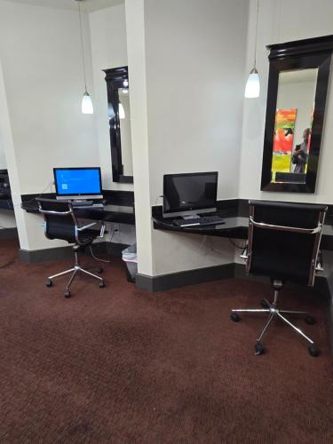 an office with two desks and two laptops on them at Downtown Dallas 2bd free parking in Dallas