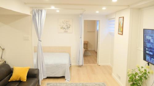 a living room with a couch and a table at Applewood Gardens Apartment in Mississauga