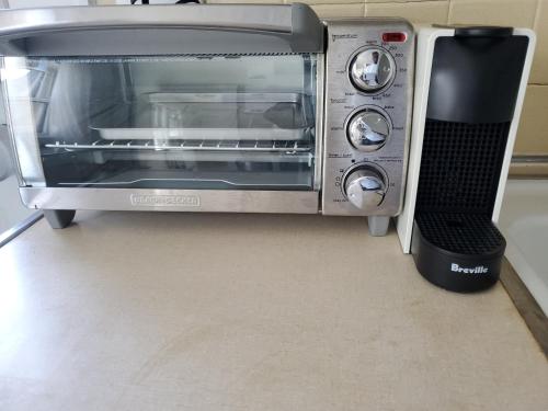 a toaster oven with a speaker next to it at Sunshine Room by harbor downtown beach I-95&Train in Stamford