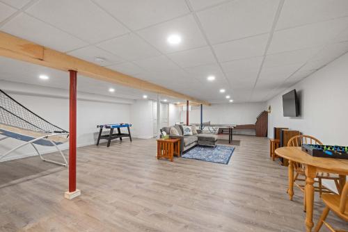 a living room with a ping pong table at Tranquil 3BR Retreat Game Room Deck Beach Pass in Center Harbor