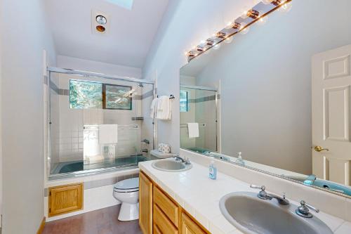 a bathroom with a sink and a toilet and a mirror at Stateline Serenity in Stateline
