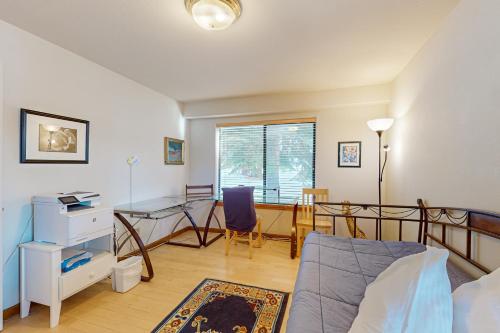 a bedroom with a bed and a desk and a table at Stateline Serenity in Stateline