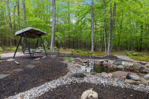 a park with a picnic table and a pond at Trails & Tranquility Great Nature Game Room in Freedom