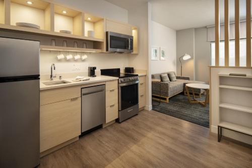 a kitchen with a sink and a stove top oven at TownePlace Suites by Marriott Cincinnati Oakley in Cincinnati