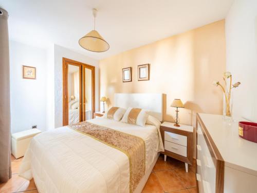 Un dormitorio con una cama blanca y una cómoda. en Apartment in Spain near Scenic Coastline, en Jávea