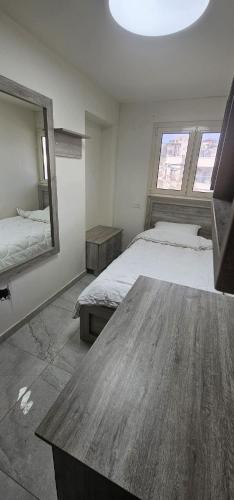 a bedroom with two beds and a wooden table at De Nice Suite in Majdal Shams
