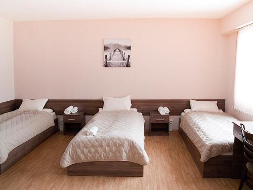 a room with two beds in a room at Motel Maritsa in Dimitrovgrad