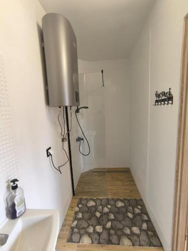 a small bathroom with a sink and a rug at Lawendowo in Koniecpol
