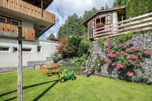 a small green tractor in a yard next to a building at Villa Krejza in Smokovce