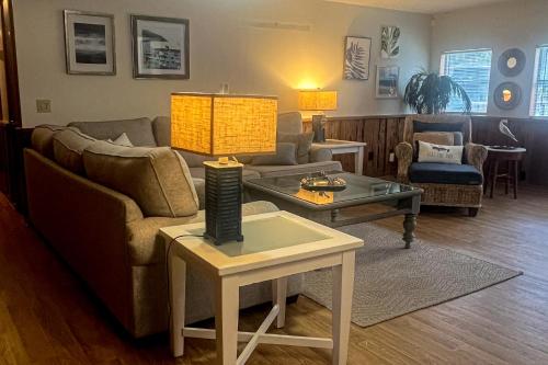 a living room with a couch and a table at Sealevel in St. George Island