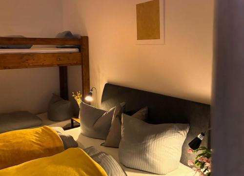 a bedroom with a bed with two bunk beds at Pension Almhof Baumgarten in Bad Reichenhall